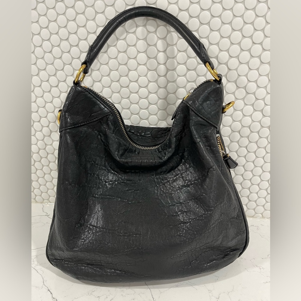 Marc Jacob’s Pebbled black leather, 2 tone zippers . A classic with an edge.